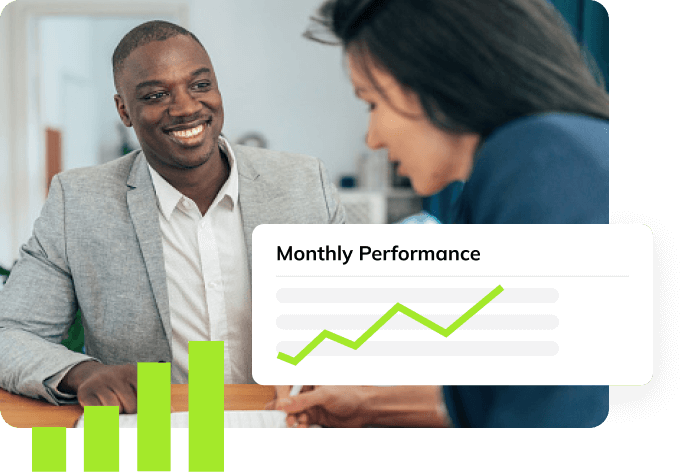 Smiling insurance agent looking at a colleague with an ascending Monthly Performance line chart. 